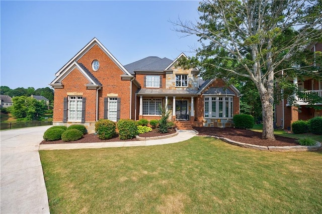 652 Pathview Ct, Dacula, GA 30019 - view of front of home featuring brick siding, a front yard, and covered porch