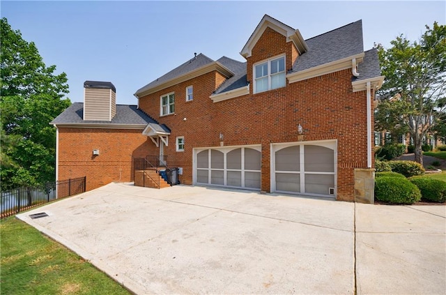 652 Pathview Ct, Dacula, GA 30019 - back of house featuring brick siding, an attached garage, concrete driveway, and a shingled roof