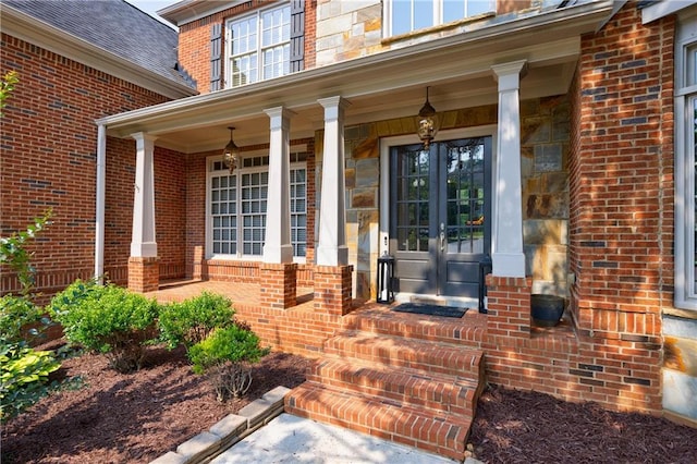 652 Pathview Ct, Dacula, GA 30019 - view of exterior entry with french doors, brick siding, and a porch