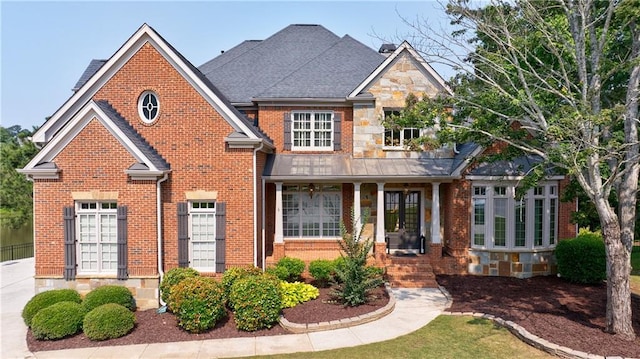 652 Pathview Ct, Dacula, GA 30019 - view of front facade with brick siding, a porch, stone siding, and a shingled roof