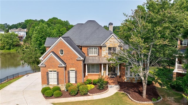 652 Pathview Ct, Dacula, GA 30019 - view of front facade with a chimney, brick siding, a water view, and concrete driveway