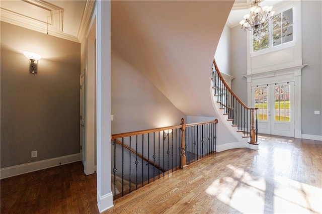 652 Pathview Ct, Dacula, GA 30019 - staircase with wood finished floors, a chandelier, ornamental molding, and baseboards