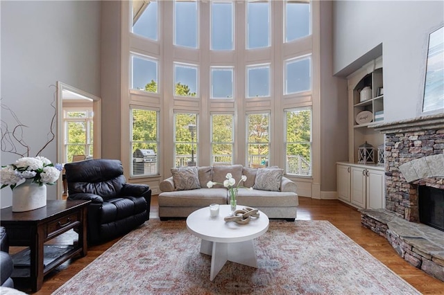 652 Pathview Ct, Dacula, GA 30019 - living area with a towering ceiling, a fireplace, wood finished floors, and baseboards