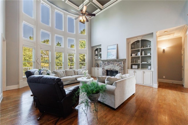 652 Pathview Ct, Dacula, GA 30019 - living room with baseboards, a high ceiling, coffered ceiling, ceiling fan, and a fireplace