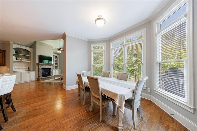 652 Pathview Ct, Dacula, GA 30019 - dining space with a glass covered fireplace, ornamental molding, healthy amount of natural light, and baseboards