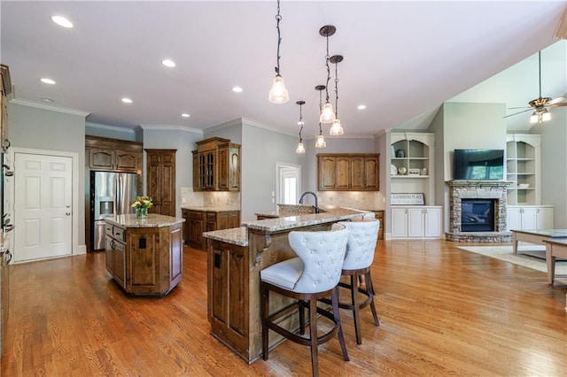 652 Pathview Ct, Dacula, GA 30019 - kitchen with a center island with sink, stainless steel refrigerator with ice dispenser, crown molding, wood finished floors, and decorative backsplash