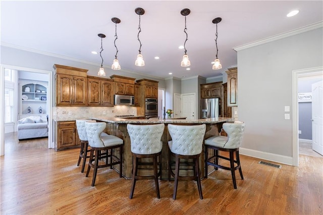 652 Pathview Ct, Dacula, GA 30019 - kitchen featuring stainless steel appliances, light wood-type flooring, a breakfast bar, light stone counters, and a spacious island