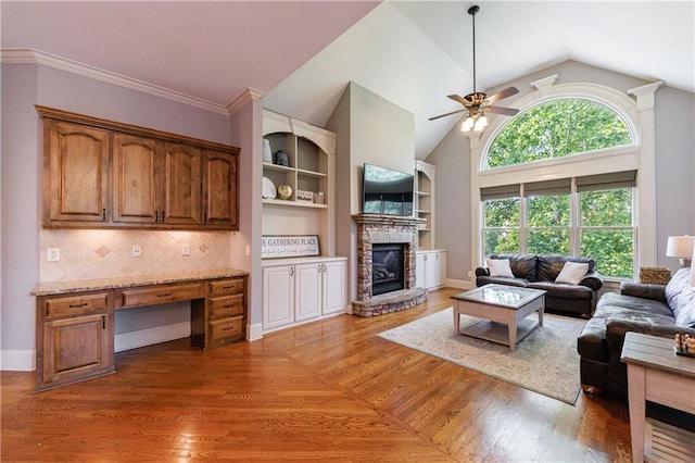 652 Pathview Ct, Dacula, GA 30019 - living room featuring a ceiling fan, a stone fireplace, lofted ceiling, wood finished floors, and baseboards