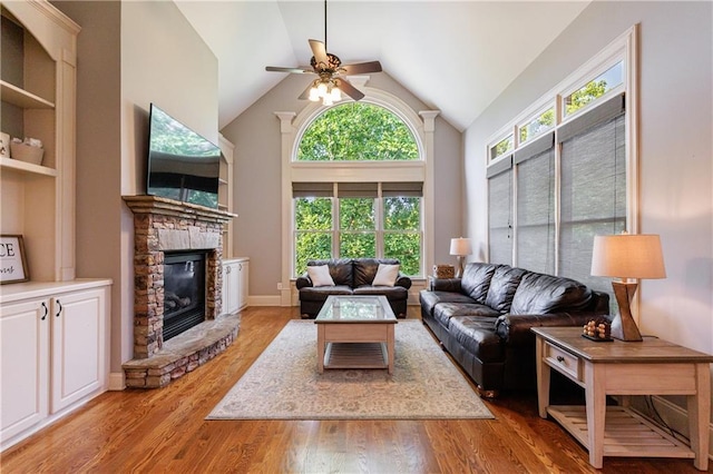 652 Pathview Ct, Dacula, GA 30019 - living area featuring a ceiling fan, a fireplace, light wood-style floors, and high vaulted ceiling