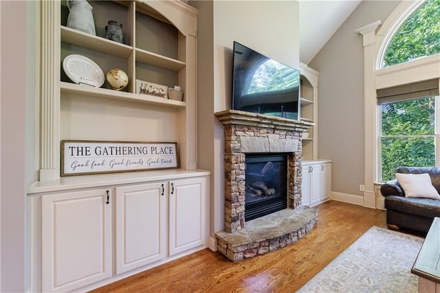 652 Pathview Ct, Dacula, GA 30019 - living area featuring light wood-style floors, a stone fireplace, and lofted ceiling