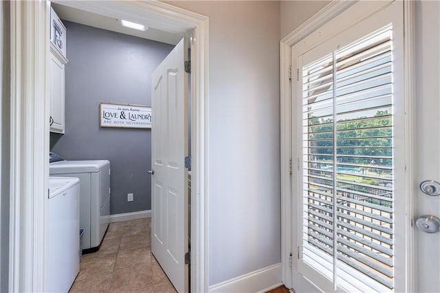 652 Pathview Ct, Dacula, GA 30019 - washroom with washing machine and dryer, cabinet space, baseboards, and light tile patterned floors