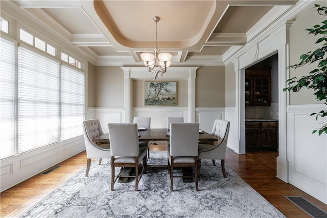 652 Pathview Ct, Dacula, GA 30019 - dining area with a chandelier, coffered ceiling, a decorative wall, a wainscoted wall, and wood finished floors