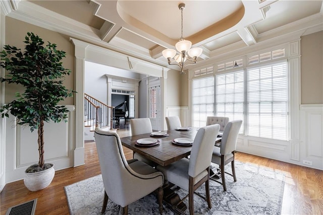 652 Pathview Ct, Dacula, GA 30019 - dining room with a chandelier, coffered ceiling, a decorative wall, stairs, and crown molding