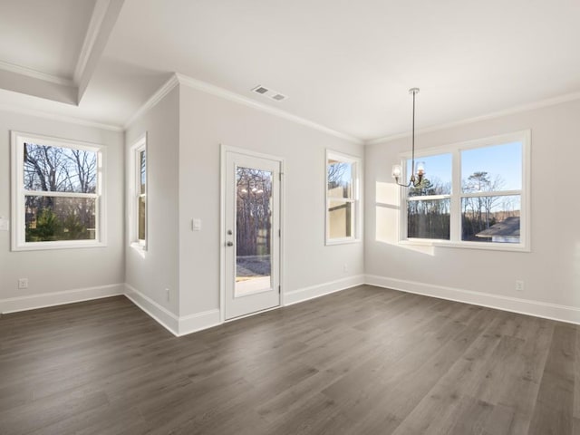 unfurnished dining area featuring dark hardwood / wood-style flooring, plenty of natural light, ornamental molding, and an inviting chandelier