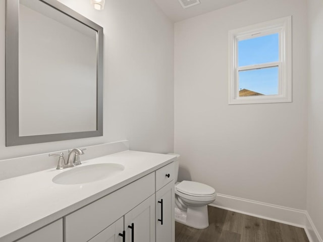 bathroom featuring vanity, hardwood / wood-style floors, and toilet