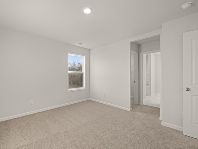 empty room with light colored carpet