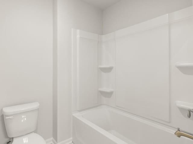 bathroom with toilet and shower / bath combination