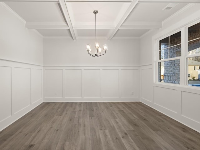 unfurnished dining area with an inviting chandelier, coffered ceiling, wood-type flooring, ornamental molding, and beamed ceiling