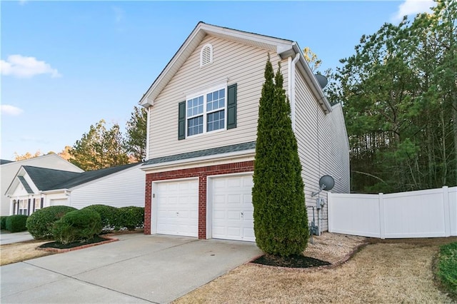 view of home's exterior featuring an attached garage, driveway, fence, and brick siding