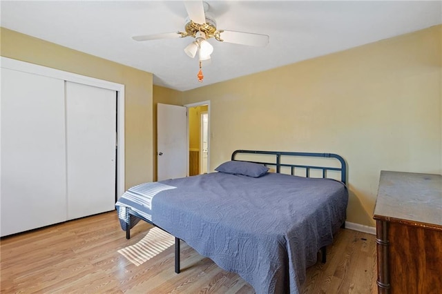 bedroom with a closet, ceiling fan, and light hardwood / wood-style floors