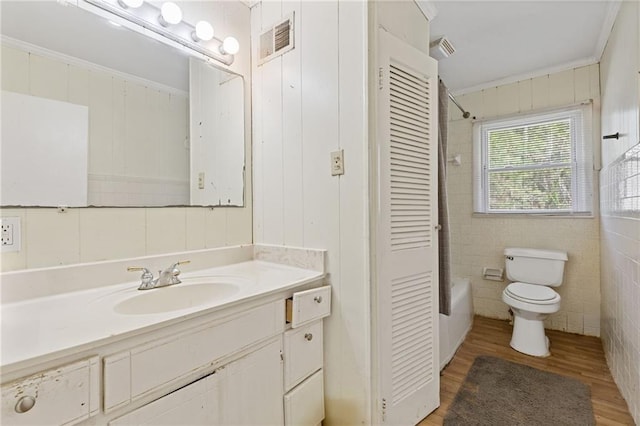 full bathroom with hardwood / wood-style flooring, vanity, toilet, and ornamental molding