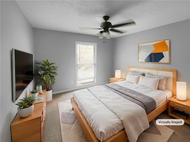 bedroom with baseboards, carpet, ceiling fan, and a textured ceiling