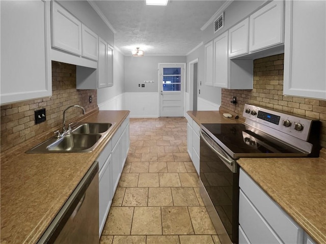 kitchen with visible vents, appliances with stainless steel finishes, white cabinetry, and a sink