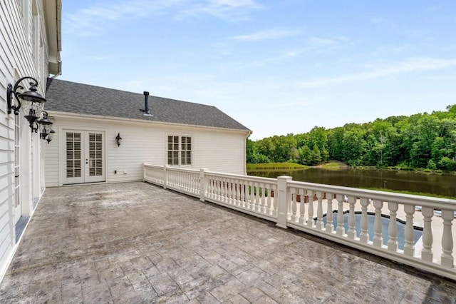 view of patio / terrace with french doors and a water view