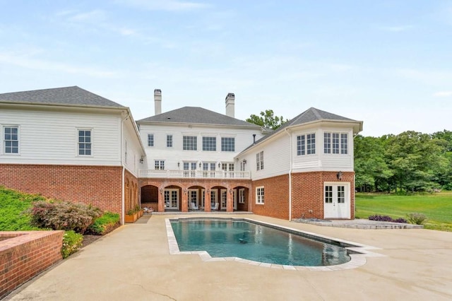 back of house featuring a patio area, french doors, and a balcony