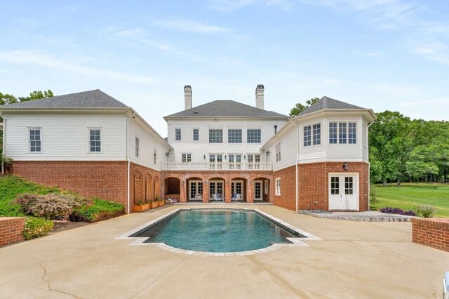 rear view of house with french doors and a patio