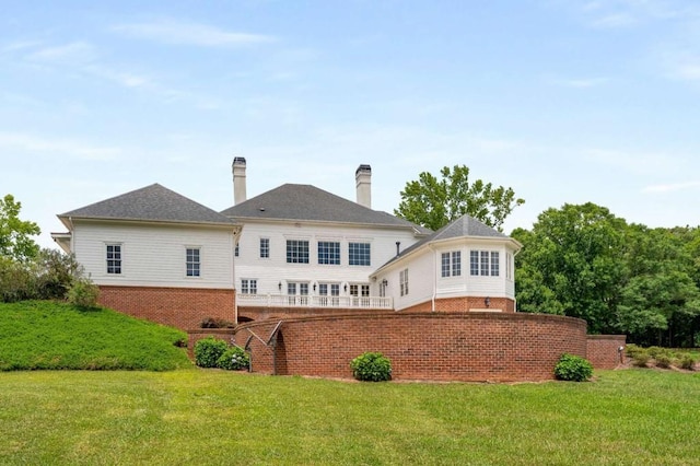 rear view of property with a lawn