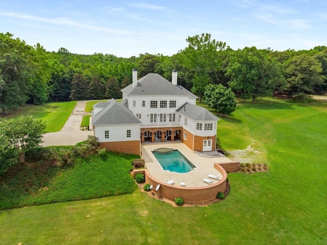 back of house with a patio area and a yard