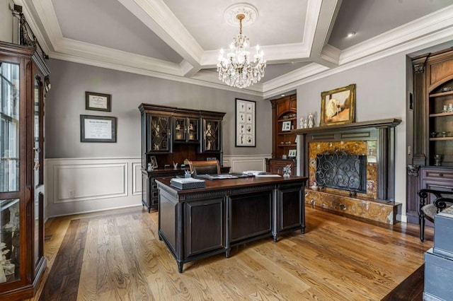 office area featuring beamed ceiling, ornamental molding, a high end fireplace, and coffered ceiling