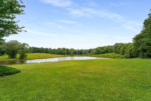 surrounding community featuring a water view and a yard