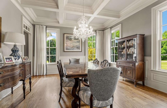 dining room featuring beam ceiling, light wood-type flooring, crown molding, and coffered ceiling