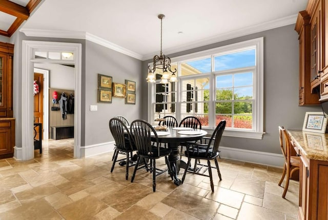 dining room with ornamental molding and a chandelier