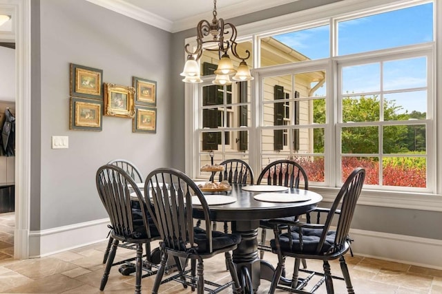 dining area with crown molding and a chandelier