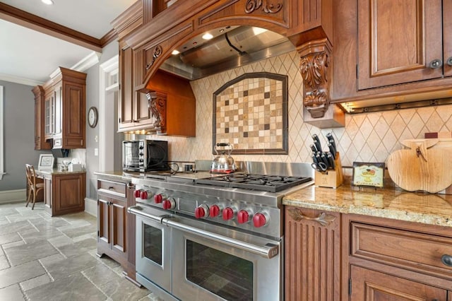 kitchen featuring wall chimney exhaust hood, light stone counters, backsplash, double oven range, and ornamental molding