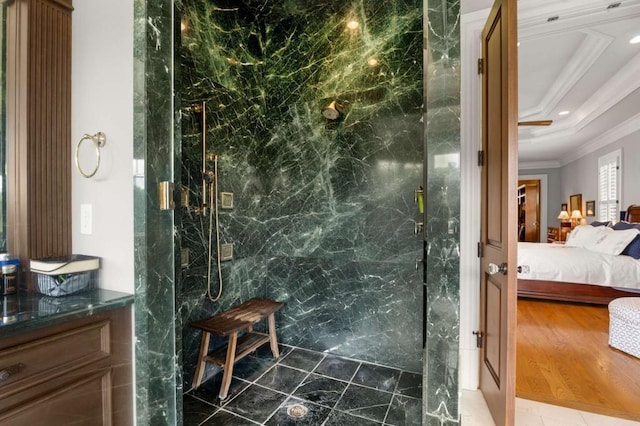 bathroom featuring a shower with shower door and crown molding