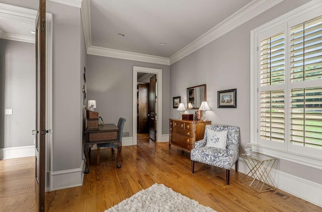 sitting room featuring light hardwood / wood-style floors and ornamental molding