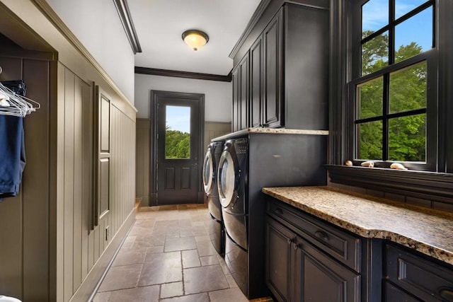 laundry area with washer and dryer, cabinets, and crown molding