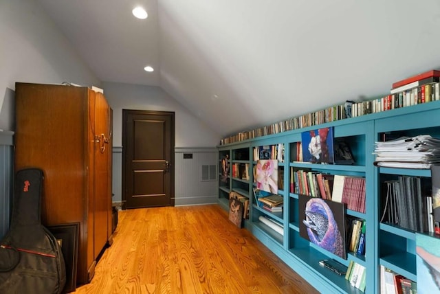 interior space with light wood-type flooring and lofted ceiling