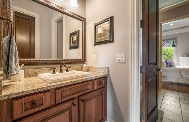 bathroom with tile patterned floors, vanity, and ornamental molding