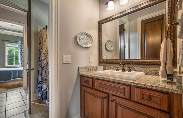 bathroom with curtained shower, tile patterned flooring, and vanity