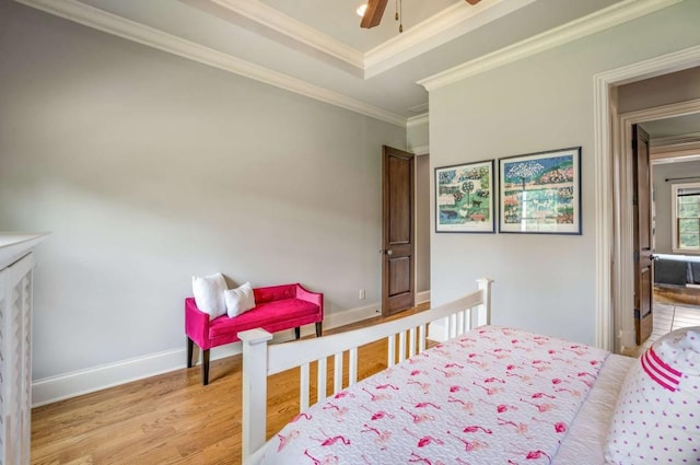 bedroom featuring ceiling fan, light wood-type flooring, and ornamental molding