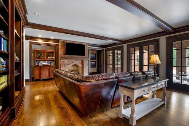 living room featuring a fireplace, beamed ceiling, wood-type flooring, and french doors