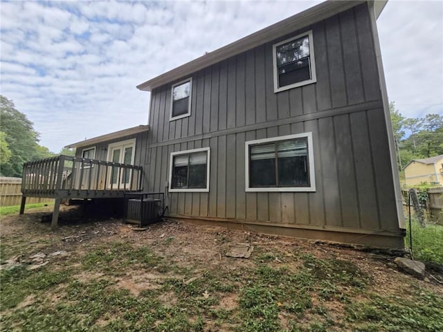 back of property featuring cooling unit and a wooden deck