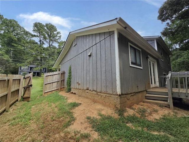 view of property exterior with a wooden deck