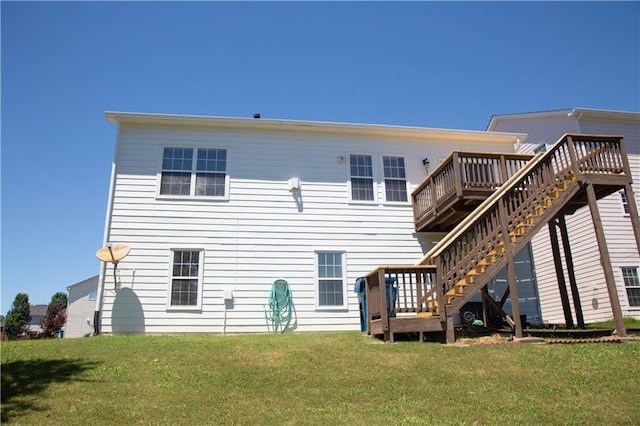 back of house featuring a wooden deck and a yard