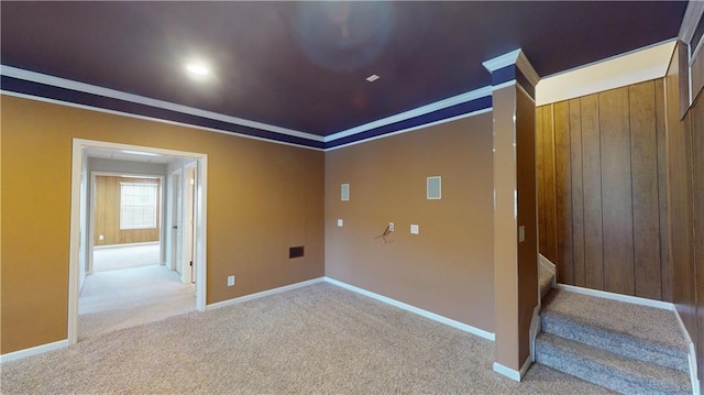 carpeted empty room featuring crown molding